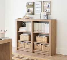 a bookshelf with baskets and pictures on the wall