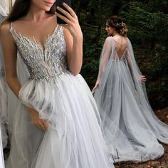 a woman taking a selfie in front of a mirror wearing a wedding dress and veil