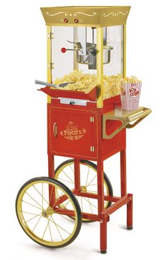 an old fashioned popcorn machine with wheels