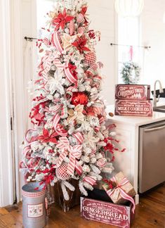 a decorated christmas tree with red and white ribbons