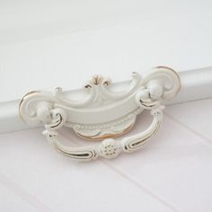 a close up of a white curtain rod