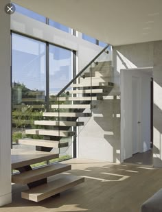 the stairs in this modern house are made of wood and glass, with no railings