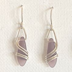 "This earring is a BEST SELLER ~ I use 20 gauge, sterling silver wire ~ which gracefully flows down & around the matte glass. This is NOT beachglass, rather they are pressed beads from the czech republic. The glass does, however, look very much like beachglass They hang 1 1/4\" x 1/4\" and are very light and super comfortable! A great, everyday earring at a great price ~ BEST SELLER 10 years & counting! Arrives, thoughtfully gift packaged on CRD printed earring card & artisan bio ~ c Handmade Silver Sea Glass Earrings, Handmade Silver Earrings With Sea Glass, Nickel-free Teardrop Earrings Made Of Recycled Glass, Nickel-free Teardrop Earrings In Recycled Glass, Silver Hypoallergenic Earrings With Sea Glass, Silver Sea Glass Drop Earrings, Silver Hypoallergenic Sea Glass Earrings, Hypoallergenic Silver Sea Glass Earrings, Elegant Recycled Glass Earrings With Ear Wire