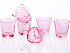 pink glass cups and glasses on a white surface