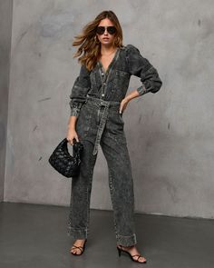 Discover the Westward Trails Belted Denim Jumpsuit, the ultimate blend of rugged charm and chic style for fall. Made from structured denim fabric, this jumpsuit is designed to keep you looking effortlessly cool as temperatures drop. The detachable waist tie accent lets you adjust the fit to your liking, while breast and side slant pockets add a touch of practicality with flair. Perfect for crisp autumn days or a weekend adventure, this jumpsuit brings a laid-back yet polished vibe to your fall w Chic Dark Wash Overall Jumpsuits And Rompers, Chic Dark Wash Jumpsuits And Rompers With Pockets, Chic Dark Wash Overall Jumpsuit, Utility Style Belted Jumpsuit For Fall, Chic Denim Belted Jumpsuits And Rompers, Trendy Winter Workwear Jumpsuits And Rompers, Denim Belted Overalls Jumpsuits And Rompers, Chic Denim Jumpsuits And Rompers For Fall, Fall Season Belted Overall Jumpsuits And Rompers