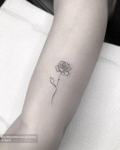 a single rose tattoo on the arm