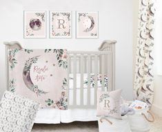 a baby's room with pink and white flowers on the wall, crib bedding, and decor