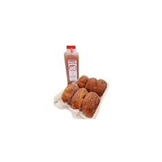 doughnuts on a tray next to a bottle of ketchup sitting on a white surface