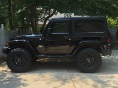 a black jeep parked in front of a house