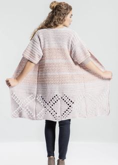 a woman wearing a pink crochet shawl with an openwork design on the back