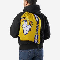 Whether you're going to work, class, or the gym, make sure you always put the team on your back. Literally. Store your stuff and show off your team spirit with this Los Angeles Rams Yellow Alternate Color Big Logo Drawstring Backpack. Features Easy adjustable cinch top cords to make storing your stuff quick and easy Screen printed design so everyone knows who you're rooting for on gameday Details Dimensions: Approximately 18 in. x 14 in. Volume: Approximately 4L Officially licensed Imported Black Bags For Sports With School Spirit Style, Black Drawstring Gym Bag For Sports, Black School Spirit Bag For College, Sporty Drawstring Backpack For The Gym, Casual Black Gym Bag For Sports Events, Sporty Gym Backpack With Drawstring, Casual Backpack For Sports Events, Eagles Kelly Green, Los Angeles Rams