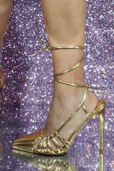 Metallic finish Faux leather upper Strappy design Tied closure around the ankle Closed pointed toe High stiletto heel