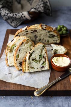 a loaf of bread sitting on top of a wooden cutting board