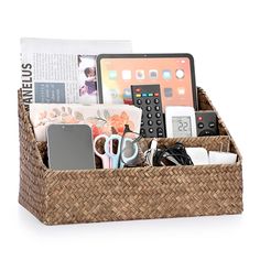 a wicker basket filled with assorted items and a remote control in front of an ipad