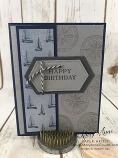 a close up of a birthday card with a brush and paper crafting supplies on it