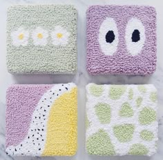 four crocheted coasters with different designs on them