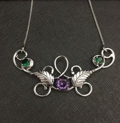 "I've created a magical, elegant bohemian style necklace for a wedding, or faery wear for any occasion. This piece is fabricated in sterling silver and features two 4mm emeralds (lab created chatham) and a center, gorgeous 8mm round Amethyst faceted gemstone. Lab created means the exact same chemical properties are invested in these stones as with earth made 'natural' variety, except the lab created versions are made in a lab, under intense high heat and pressure to produce them quickly. It brin Bohemian Amethyst Wedding Jewelry, Bohemian Amethyst Jewelry With Intricate Design, Bohemian Purple Hand Forged Necklace, Fantasy Style Silver Amethyst Jewelry, Fantasy Style Amethyst Silver Jewelry, Fantasy Amethyst Silver Jewelry, Handmade Fantasy Style Necklace For Wedding, Bohemian Hand Forged Wedding Jewelry, Wedding Circlet