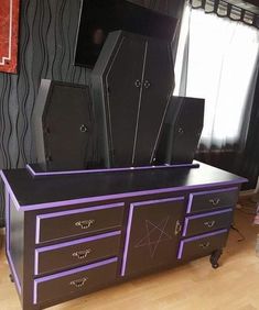 a purple and black dresser with speakers on it