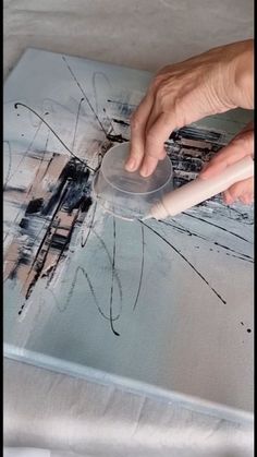 a person using a computer mouse on top of a book with an ink pen in it