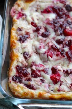 a casserole dish with cranberry sauce and cheese