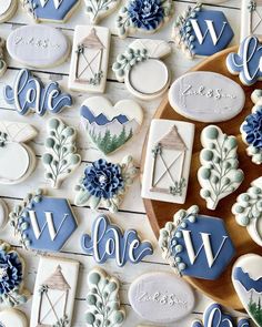 cookies decorated with blue and white icing on a table