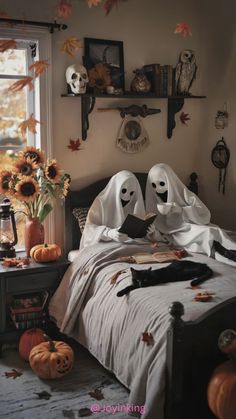 two ghost reading a book on a bed with sunflowers and pumpkins in the background