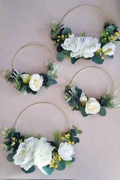 three hoop wreaths with white flowers and greenery