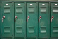 a row of green lockers sitting next to each other