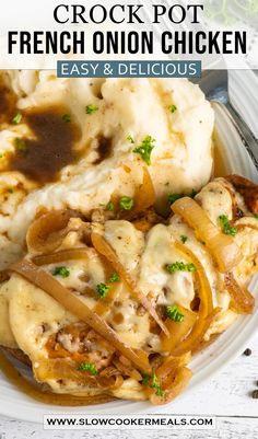 a white plate topped with mashed potatoes covered in gravy