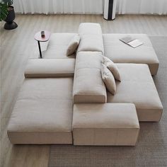 a large sectional couch with pillows on it