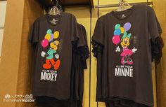 two t - shirts with mickey mouse on them hanging in a closet