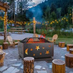 an outdoor fire pit surrounded by wooden logs