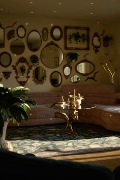 a living room filled with furniture and mirrors