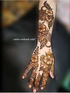 the hand is decorated with flowers and leaves