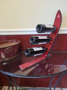 three bottles of wine sitting on top of a glass table