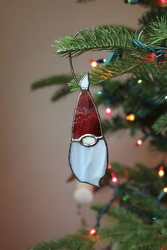 a stained glass ornament hanging from a christmas tree