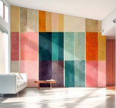 a living room with a couch, table and colorful wallpaper on the walls behind it