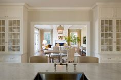 a kitchen and dining room with marble counter tops