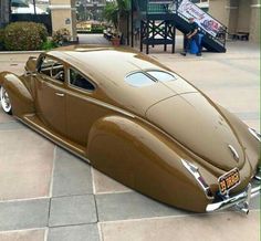 an antique car parked in front of a building