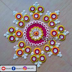 an intricate design on the floor with white and yellow circles around it, surrounded by beads