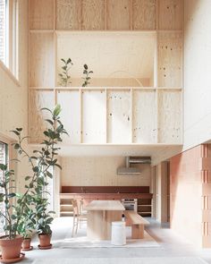 the interior of a house with wood paneling and potted plants on the floor