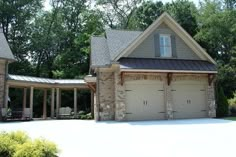 two garages in front of a large house