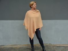 No matter how old you are you can always shine beauty and femininity everywhere you go! This geometric cotton poncho / triangle shawl looks simply gorgeous on women of all sizes and can easily be a plus size shoulder cape for those bigger beautiful ladies as well as a loose fit wrap that is so comfortable to wear for slim/athletic ladies! Made from soft 100% cotton muslin (double gauze) fabric they are easy to take care. Find out for yourself why this warm poncho is so perfect for everyday use in the spring, winter and autumn! We promise with these poncho you will draw all the attention in the crowd! -The model is wearing size 4 XL US (50 EU) and she is 176 cm tall; -      it is one size (the best from S US (36 EU) to 5/6 XL US (52/54 EU)); -it is  sand color, but you can choose any color Oversized Shawl Poncho, Oversized Poncho Shawl With Scarf Detail, Oversized Beige Shawl Poncho, Women Of All Sizes, Shoulder Cape, Triangle Shawl, Always Shine, Ladies Poncho, Triangle Shawls