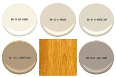 six different shades of white paint with wood flooring in the middle and below them