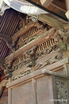 an intricately carved wooden structure on the side of a building