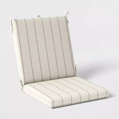 a white chair cushion with pinstripe pattern on the front and back, facing outward