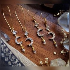 Listing is for ONE (1) pair of earrings.  These beautiful crescent moon earrings are crafted with gold plated pyrite beads, gold plated crystal moon charms, glass diamond shaped charms, Czech faceted glass beads, & matching hoops + your preference of hook style. ▪︎▪︎▪︎▪︎▪︎ * (Quantity: ONE (1) pair each - Though others may be recreated similarly, it may take longer depending on supply inventory, please contact me.) * Please note that as each product is handmade, each one will be unique and one o Gold Crescent Spiritual Earrings, Gold Moon Charm Drop Earrings, Gold Drop Earrings With Moon Charm, Mystical Gold Moon Phase Earrings, Mystical Crescent Brass Earrings, Celestial Gold Dangle Cartilage Earrings, Gold Moon-shaped Earrings With Moon Charm, Gold Crescent Earrings With Moon Phase Detail, Spiritual Crescent Earrings For Gift