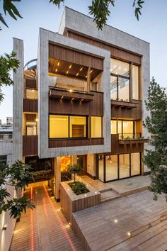 an apartment building with stairs leading up to the second floor and two stories above it