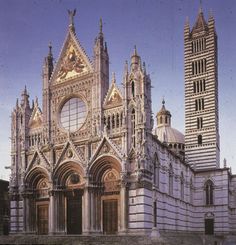 an ornate building with two towers and a clock tower