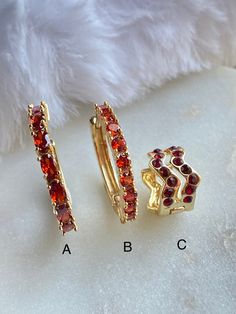 "These red CZ Hoop and Huggie Earrings are 18K Gold Filled. There are three styles available with a lever back closure: A. This is a medium sized hoop with oval reddish CZ stone. The stone color is more true to a fire brick red. dimension: 19mm x 19mm (approximately 3/4\")   B. A medium sized hoop with a round \"brick red\" CZ stone. Diameter: 18mm C. Huggie are a small hoop that hugs the ear lobe when you wear it. This Huggie earring comes with dark red CZ stone. it measures approximately .5\" in diameter and .5\" in height.  Hypoallergenic Nickel Free Water & Sweat Resistant  18K Gold Filled / Oro Laminado 18K" Small Red Hypoallergenic Hoop Earrings, Red Adjustable Hypoallergenic Hoop Earrings, Red Hoop Jewelry For Anniversary, Red Hypoallergenic Hoop Jewelry, Red Hoop Huggie Earrings, Red Huggie Earrings For Anniversary, Red Small Hoop Jewelry For Anniversary, Red Ruby Hoop Earrings, Elegant Small Red Hoop Earrings